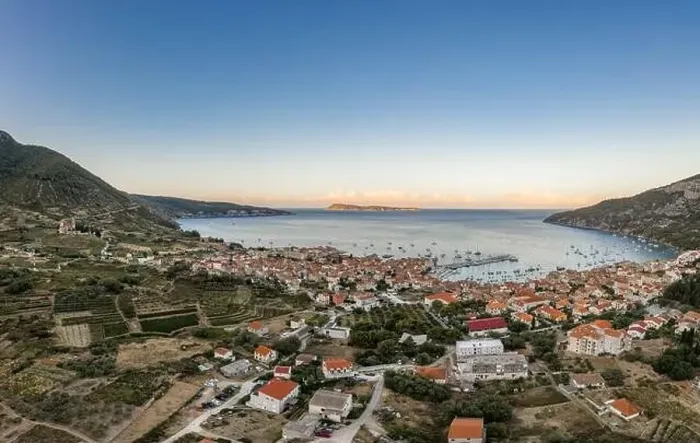Framed Print : Aerial drone shot of adriatic sea Komiza town on Vis Island with view of Bisevo Island in Croatia summer sunrise Framed Print : Aerial drone shot of adriatic sea Komiza town on Vis Island with view of Bisevo Island in Croatia summer sunrise