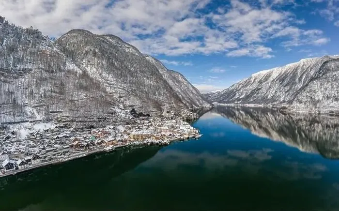 Framed Print : Aerial drone shot of Austrian snowy village by Hallstatt lake under blue sky in winter snowy time Framed Print : Aerial drone shot of Austrian snowy village by Hallstatt lake under blue sky in winter snowy time