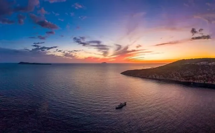 Framed Print : Aerial drone shot of boat drifting in Adriatic sea with sunset burning sky on Komiza over Vis Island in Croatia Summer Framed Print : Aerial drone shot of boat drifting in Adriatic sea with sunset burning sky on Komiza over Vis Island in Croatia Summer