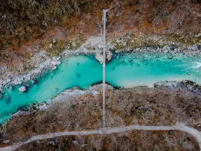 Framed Print : Aerial drone shot of bridge over the beautiful crystal blue Soca River at the Kozjak fall in Slovenia, Europe Framed Print : Aerial drone shot of bridge over the beautiful crystal blue Soca River at the Kozjak fall in Slovenia, Europe