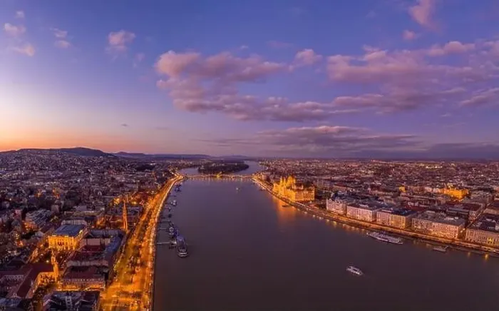 Framed Print : Aerial drone shot of Danube river with lighted quai with purple sky during Budapest sunset Framed Print : Aerial drone shot of Danube river with lighted quai with purple sky during Budapest sunset