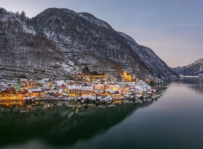Framed Print : Aerial drone shot of Hallstatt village covered by snow during du Framed Print : Aerial drone shot of Hallstatt village covered by snow during du