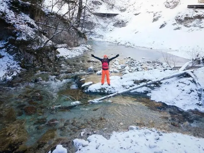 Framed Print : Aerial drone shot of hiker with backpack, orange cap and orange pants next to cold mountain stream in canyon Framed Print : Aerial drone shot of hiker with backpack, orange cap and orange pants next to cold mountain stream in canyon