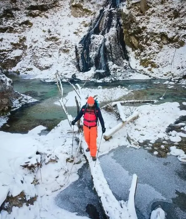 Framed Print : Aerial drone shot of hiker with backpack, orange cap and orange pants next to cold mountain stream in canyon Framed Print : Aerial drone shot of hiker with backpack, orange cap and orange pants next to cold mountain stream in canyon