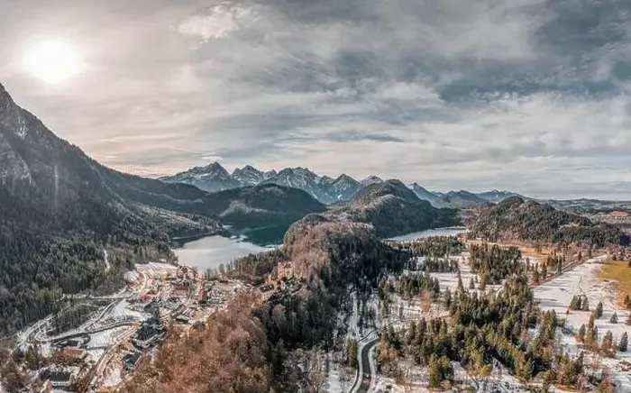 Framed Print : Aerial drone shot of Hohenschwangau by lake in Fussen with view of Alps snow mountain range in Germany winter