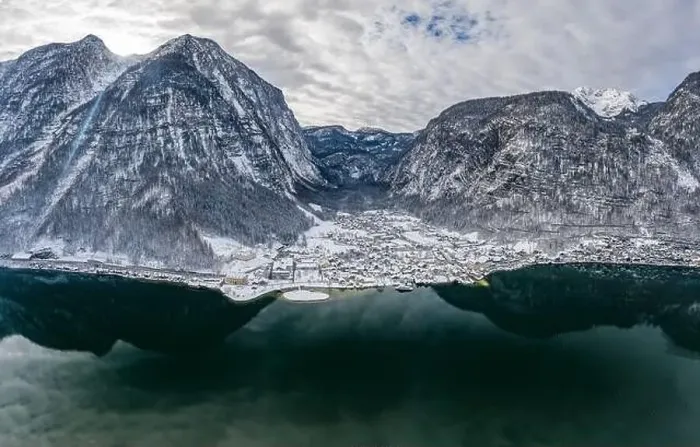 Framed Print : Aerial Drone shot of Lahn village by Hallstatt lake at foot of Austrian Alps mountain with clouds in winter