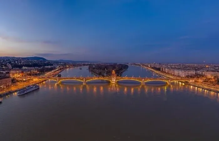 Framed Print : Aerial drone shot of Margaret Bridge with lights on over Danube river during Budapest sunset Framed Print : Aerial drone shot of Margaret Bridge with lights on over Danube river during Budapest sunset