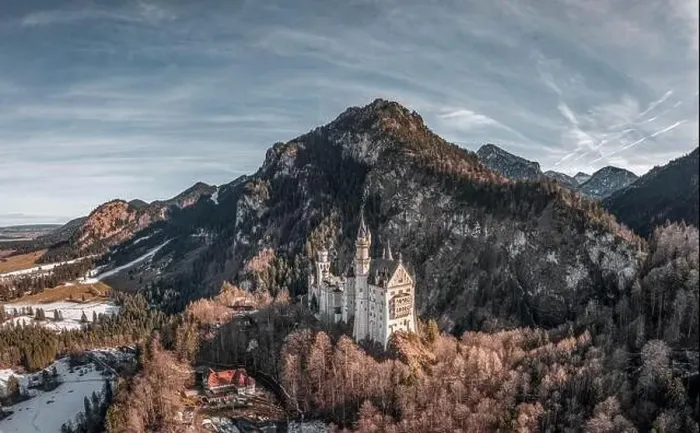 Framed Print : Aerial drone shot of picturesque Neuschwanstein Castle on snowy hill in winter sunlight in Germany Framed Print : Aerial drone shot of picturesque Neuschwanstein Castle on snowy hill in winter sunlight in Germany