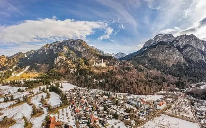 Framed Print : Aerial drone shot of picturesque Neuschwanstein Castle on snowy hill in winter sunlight in Germany Framed Print : Aerial drone shot of picturesque Neuschwanstein Castle on snowy hill in winter sunlight in Germany