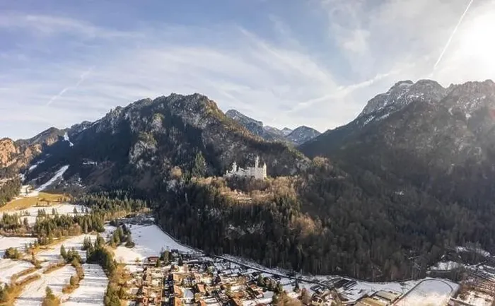 Framed Print : Aerial drone shot of picturesque Neuschwanstein Castle on snowy hill in winter sunlight in Germany Framed Print : Aerial drone shot of picturesque Neuschwanstein Castle on snowy hill in winter sunlight in Germany