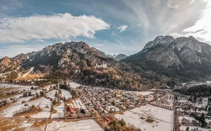 Framed Print : Aerial drone shot of picturesque Neuschwanstein Castle on snowy hill in winter sunlight in Germany Framed Print : Aerial drone shot of picturesque Neuschwanstein Castle on snowy hill in winter sunlight in Germany