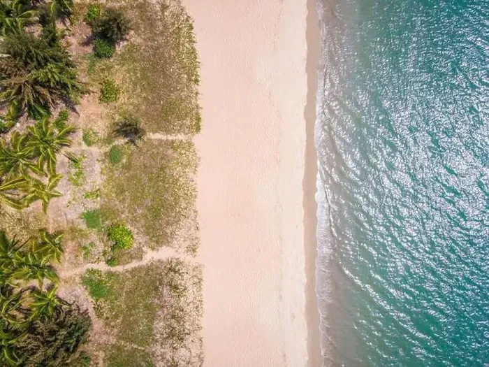 Framed Print : Aerial top down drone shot of empty Sanya bay beach with white sand and water on Hainan tropical island China Framed Print : Aerial top down drone shot of empty Sanya bay beach with white sand and water on Hainan tropical island China