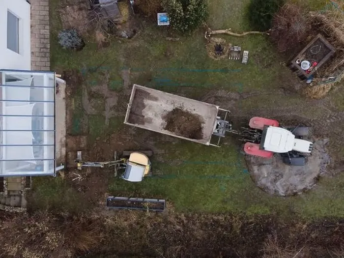Framed Print : aerial drone shot of small, yellow excavator stands in a large garden and digs a hole for a pool in austria Framed Print : aerial drone shot of small, yellow excavator stands in a large garden and digs a hole for a pool in austria