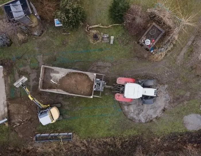 Framed Print : aerial drone shot of small, yellow excavator stands in a large garden and digs a hole for a pool in austria Framed Print : aerial drone shot of small, yellow excavator stands in a large garden and digs a hole for a pool in austria