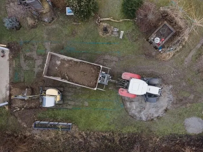 Framed Print : aerial drone shot of small, yellow excavator stands in a large garden and digs a hole for a pool in austria Framed Print : aerial drone shot of small, yellow excavator stands in a large garden and digs a hole for a pool in austria