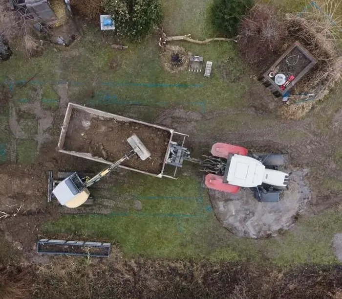 Framed Print : aerial drone shot of small, yellow excavator stands in a large garden and digs a hole for a pool in austria Framed Print : aerial drone shot of small, yellow excavator stands in a large garden and digs a hole for a pool in austria