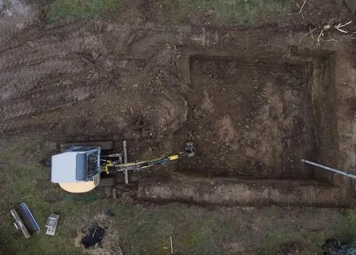 Framed Print : aerial drone shot of small, yellow excavator stands in a large garden and digs a hole for a pool in austria Framed Print : aerial drone shot of small, yellow excavator stands in a large garden and digs a hole for a pool in austria