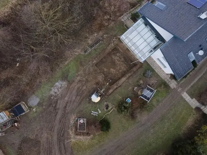 Framed Print : aerial drone shot of small, yellow excavator stands in a large garden and digs a hole for a pool in austria Framed Print : aerial drone shot of small, yellow excavator stands in a large garden and digs a hole for a pool in austria