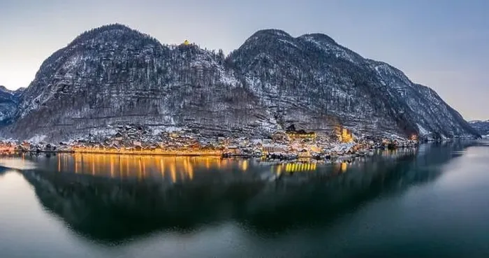 Framed Print : Aerial drone shot of snowy Hallstatt village by lake with lights Framed Print : Aerial drone shot of snowy Hallstatt village by lake with lights