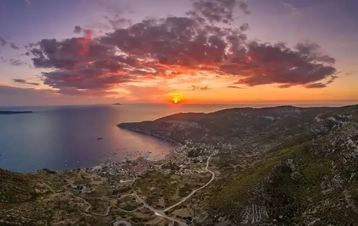 Framed Print : Aerial drone shot sunset over Adriatic horizon burning sky in Komiza port on Vis Island in Croatia summer Framed Print : Aerial drone shot sunset over Adriatic horizon burning sky in Komiza port on Vis Island in Croatia summer