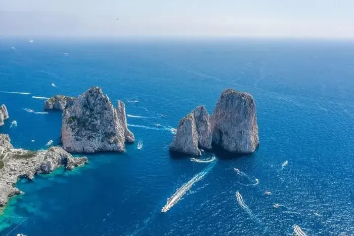 Framed Print : Aerial drone shot view of faraglioni limestone crags in summer time in Tyrrhenian sea off Capri Island with yachts Framed Print : Aerial drone shot view of faraglioni limestone crags in summer time in Tyrrhenian sea off Capri Island with yachts