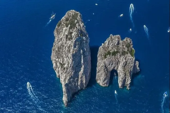 Framed Print : Aerial drone shot view of faraglioni limestone crags in summer in Tyrrhenian sea with yachts off Capri Island Framed Print : Aerial drone shot view of faraglioni limestone crags in summer in Tyrrhenian sea with yachts off Capri Island