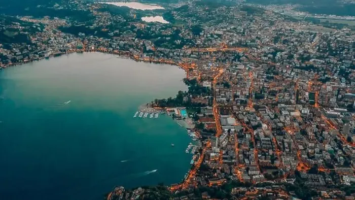 Framed Print : Aerial drone shot view of Lugano city by the lake with street light at dusk after sunset Framed Print : Aerial drone shot view of Lugano city by the lake with street light at dusk after sunset