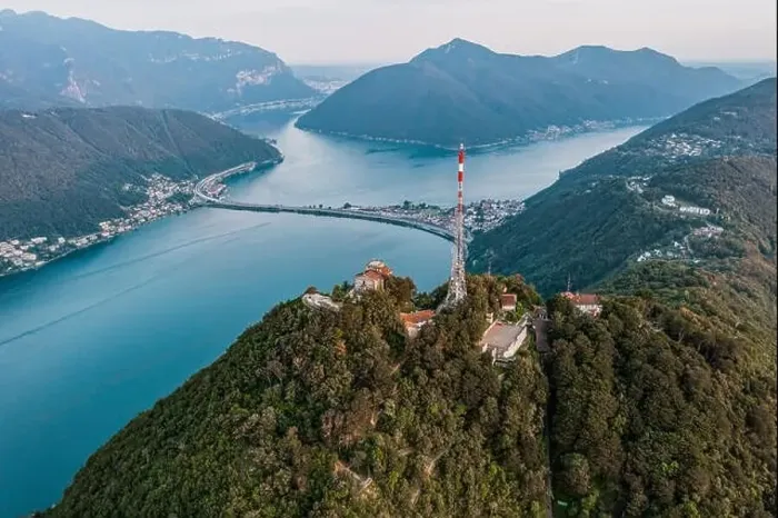 Framed Print : Aerial drone shot view of top of monte salvatore, san giorgio, and bridge diga di melide in swiss italian border Framed Print : Aerial drone shot view of top of monte salvatore, san giorgio, and bridge diga di melide in swiss italian border