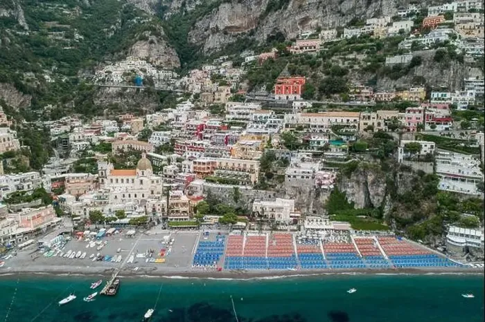 Framed Print : Aerial drone shot view of Positano village and beach with parasols in the morning in Amalfi Coast, Salerno Framed Print : Aerial drone shot view of Positano village and beach with parasols in the morning in Amalfi Coast, Salerno