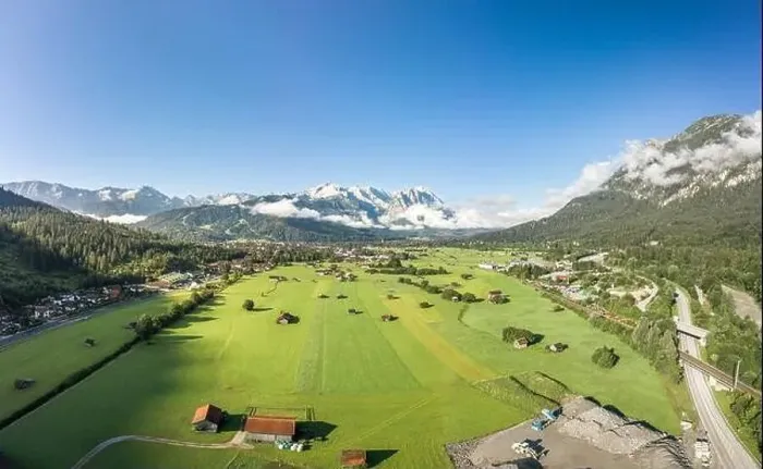 Framed Print : Aerial drone shot of village Garmisch Partenkirchen with view of Zugspitze in fog Framed Print : Aerial drone shot of village Garmisch Partenkirchen with view of Zugspitze in fog