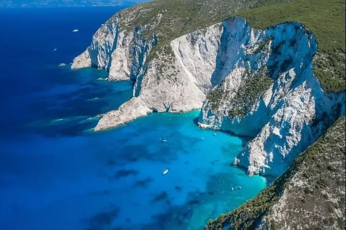 Framed Print : Aerial drone shot of Zakynthos Navagio beach cliffs by blue Ionian sea in summer Framed Print : Aerial drone shot of Zakynthos Navagio beach cliffs by blue Ionian sea in summer