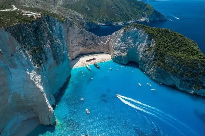 Framed Print : Aerial drone shot of Zakynthos Navagio beach with tourists with cruise ship in blue Ionnian sea Framed Print : Aerial drone shot of Zakynthos Navagio beach with tourists with cruise ship in blue Ionnian sea