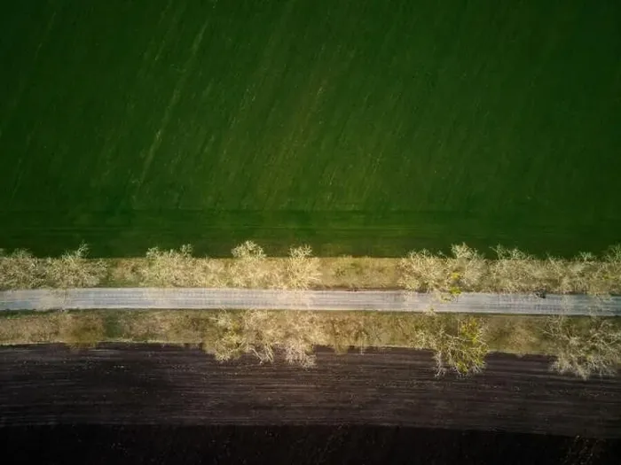 Framed Print : Aerial drone top view flight over ground land road and green field Framed Print : Aerial drone top view flight over ground land road and green field