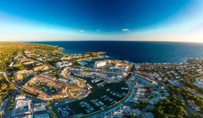Framed Print : Aerial drone view of the harbor, housing and the beach of Cala en Bosc on the Spanish island of Menorca Framed Print : Aerial drone view of the harbor, housing and the beach of Cala en Bosc on the Spanish island of Menorca