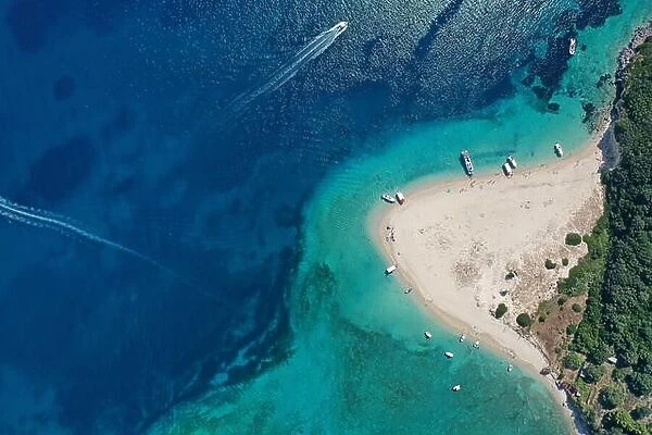 Aerial drone view of iconic small uninhabited island of Marathonisi featuring clear water, sandy shore and natural hatchery of Caretta-Caretta sea tur