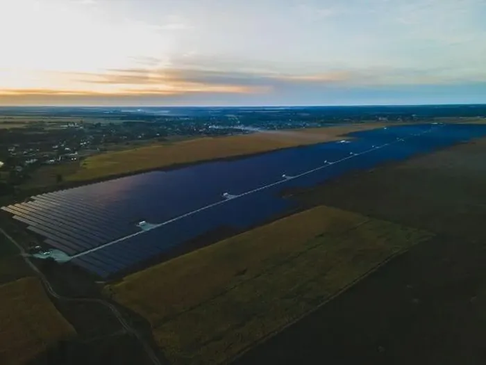 Framed Print : Aerial drone view into large solar panels at a solar farm in large field on countryside at bright sunset