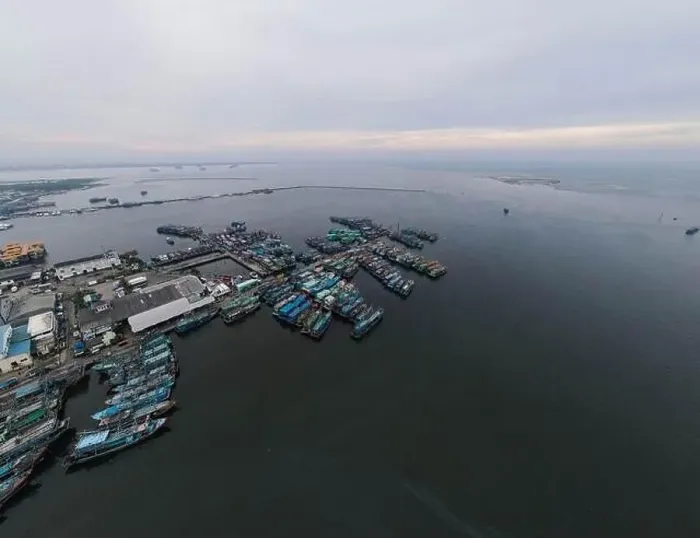Framed Print : Aerial drone view of Muara Angke Beach with wooden boats leaning beside the pier Framed Print : Aerial drone view of Muara Angke Beach with wooden boats leaning beside the pier