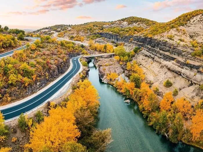 Framed Print : Aerial drone view of a road passing a narrow gorge of a river by bridge during golden autumn in Greece Framed Print : Aerial drone view of a road passing a narrow gorge of a river by bridge during golden autumn in Greece