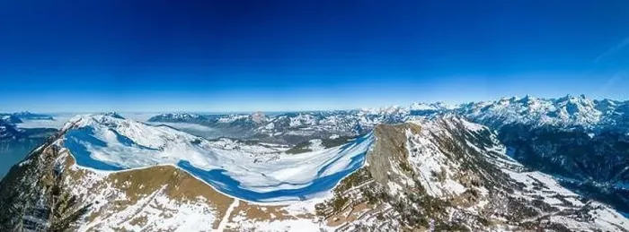 Framed Print : Aerial drone view of snow covered mountains and ski slopes, ski area Stoos, Switzerland Framed Print : Aerial drone view of snow covered mountains and ski slopes, ski area Stoos, Switzerland