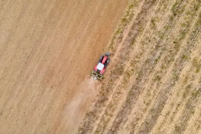 Framed Print : aerial drone view of a tractor plowing in a field Framed Print : aerial drone view of a tractor plowing in a field