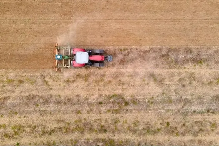 Framed Print : aerial drone view of a tractor plowing in a field Framed Print : aerial drone view of a tractor plowing in a field