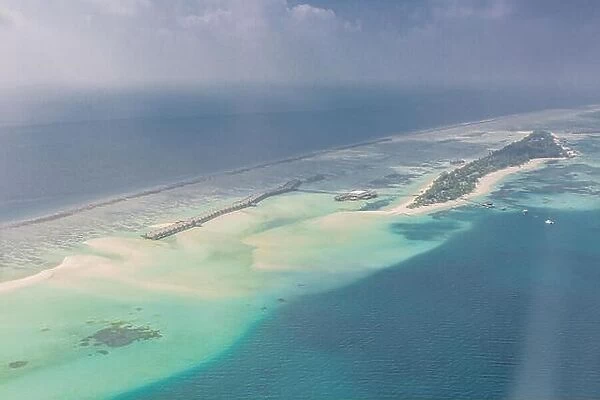 Aerial Maldives island landscape in early morning with resort beach from luxury tropical hotel vacation and holiday