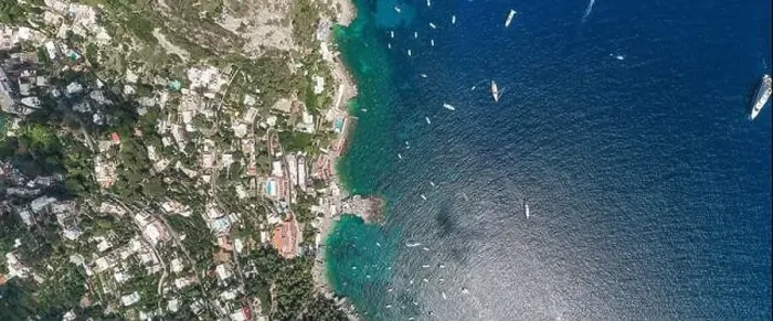 Framed Print : Aerial overhead drone panoramic shot of southern Capri Island coastline with yachts in summer noon Framed Print : Aerial overhead drone panoramic shot of southern Capri Island coastline with yachts in summer noon