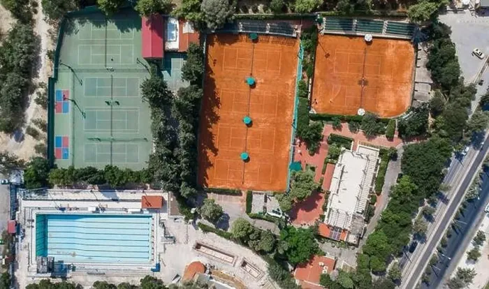 Framed Print : Aerial overhead drone shot of hard and clay tennis court besides swimming pool in Athens Framed Print : Aerial overhead drone shot of hard and clay tennis court besides swimming pool in Athens