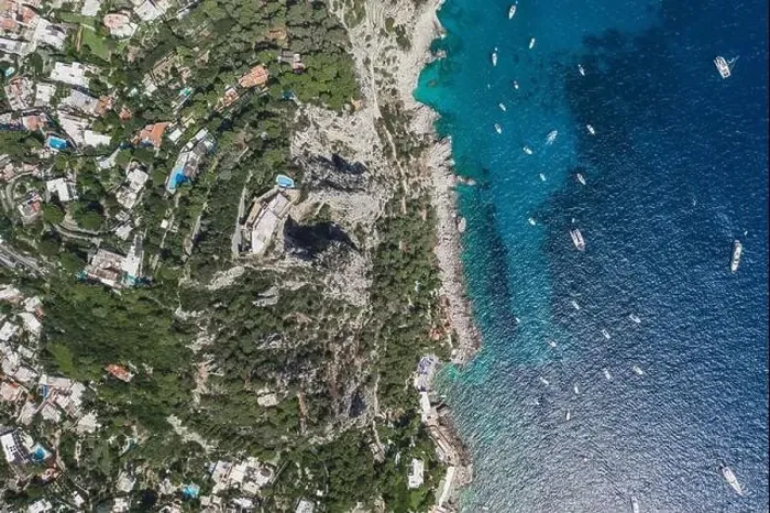 Framed Print : Aerial overhead drone shot of mountain top villa with pool above big mountain hole cave in south Capri Island Framed Print : Aerial overhead drone shot of mountain top villa with pool above big mountain hole cave in south Capri Island