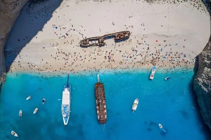 Framed Print : Aerial overhead drone shot of Zakynthos Navagio beach full of tourists and cruise ship in Ionian sea in Greece Framed Print : Aerial overhead drone shot of Zakynthos Navagio beach full of tourists and cruise ship in Ionian sea in Greece