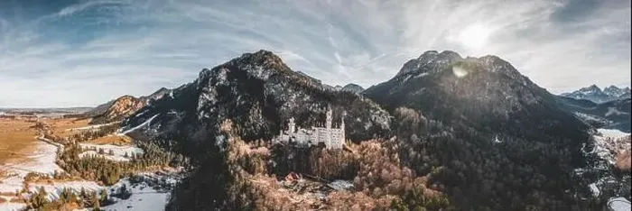Framed Print : Aerial panorama drone shot of picturesque Neuschwanstein Castle on snowy hill in winter sunlight in Germany Framed Print : Aerial panorama drone shot of picturesque Neuschwanstein Castle on snowy hill in winter sunlight in Germany