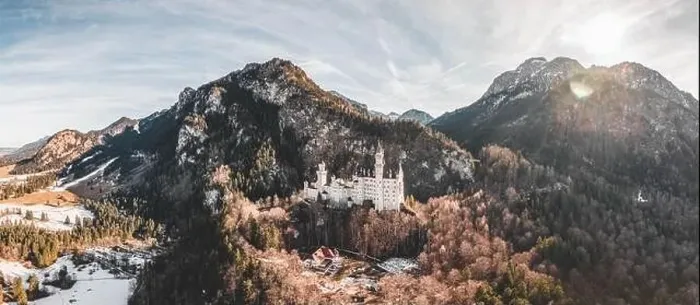 Framed Print : Aerial panorama drone shot of picturesque Neuschwanstein Castle on snowy hill in winter sunlight in Germany Framed Print : Aerial panorama drone shot of picturesque Neuschwanstein Castle on snowy hill in winter sunlight in Germany