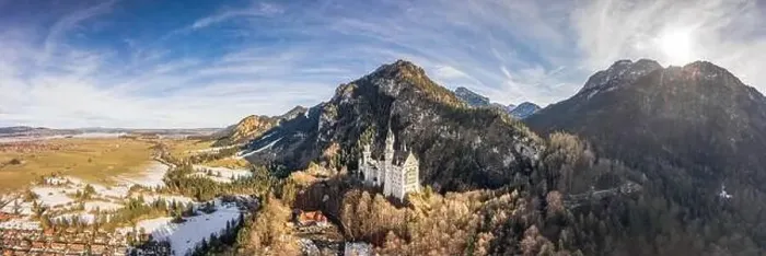 Framed Print : Aerial panorama drone shot of picturesque Neuschwanstein Castle on snowy hill in winter sunlight in Germany Framed Print : Aerial panorama drone shot of picturesque Neuschwanstein Castle on snowy hill in winter sunlight in Germany
