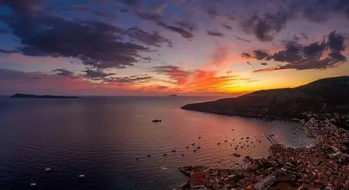 Framed Print : Aerial panorama drone shot of sunset burning sky clouds on Komiza town over Vis Island in Croatia Summer Framed Print : Aerial panorama drone shot of sunset burning sky clouds on Komiza town over Vis Island in Croatia Summer